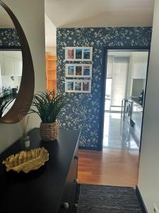 a kitchen with a black counter and a blue wall at Rodamar Apartment in Funchal