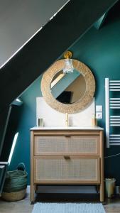 a mirror on top of a dresser in a room at Domaine du Turbais in Luynes
