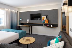 a hotel room with a bed and a couch at Holiday Inn Istanbul - Beylikduzu by IHG in Istanbul
