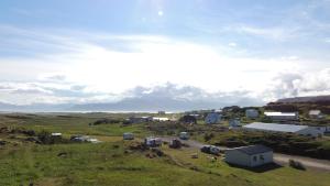 an aerial view of a small town in a field at Framtid Camping Lodging Barrels in Djúpivogur +18 photos