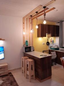 a kitchen with a table and some chairs in a room at Liza N Homes in Bungoma
