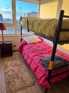 a bunk bed in a room with a window at Concep Centro Freiré-Tucapel in Concepción