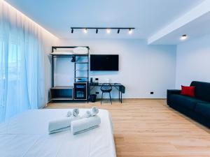 a living room with a bed and a couch at LumiaRooms B&B in Milazzo
