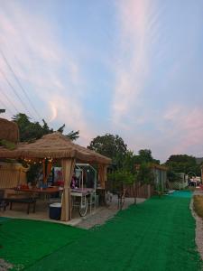 a green lawn with a tent and a picnic table at 復古車露營住宿 in Hong Kong +17 photos