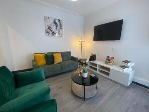 a living room with a couch and a table at Wadham Suites in Liverpool