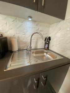 a kitchen counter with a sink in a kitchen at Wadham Suites in Liverpool +63 photos