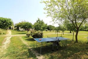 a ping pong table in the middle of a park at Silea Apartments, Pool, Garden, Treviso in Silea
