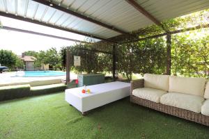 a living room with a white couch and a table at Silea Apartments, Pool, Garden, Treviso in Silea