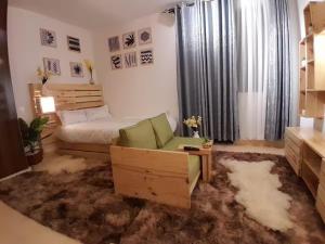 a bedroom with a bed and a couch and a chair at Liza N Homes in Bungoma +16 photos