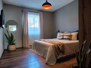a bedroom with a bed and a large window at Apartments Vidanovic in Ohrid +103 photos
