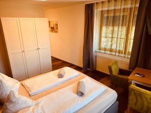 a bedroom with two beds and a window at Enns Sleep Self Check In in Enns +118 photos