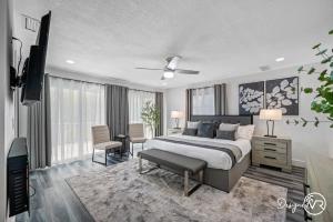 a bedroom with a bed and a television in it at Luxury Retreat: Pool Games Basketball More in Largo