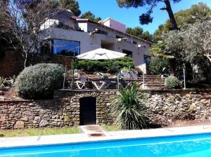 a house with a swimming pool in front of a house at Lujosa casa con piscina privada in Begur