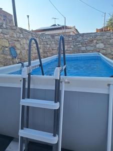 a swimming pool with a ladder in front of a swimming pool at Sofias Studio in Koroni