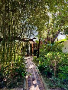 a garden with a brick path leading to a house at The Secret Garden Hideaway in Mossel Bay