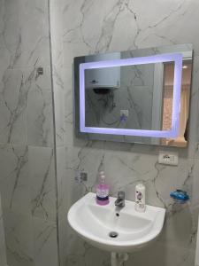 a bathroom with a sink and a mirror at Drymades Retreat, Dhërmi in Gjilek