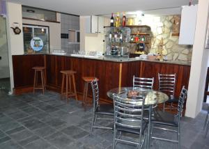 a bar with a table and chairs in a restaurant at Pousada Terra Garrida in Maceió