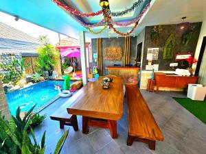 a living room with a wooden table and a swimming pool at Arawan Pool Villa Hua Hin in Hua Hin +239 photos