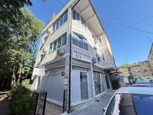 a building on a street with a car parked in front at Museum Boutique Hotel Tirana in Tirane