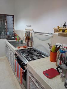 a kitchen with a stove and a sink at Nyumba ya Bubi in Watamu