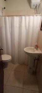 a bathroom with a white shower curtain and a sink at "La morenita", acogedora cabaña para dos in Santa Ana +19 photos
