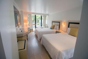 a hotel room with two beds and a balcony at Hotel Stella Maris in Mexico City +47 photos