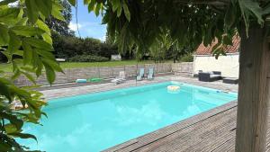 una piscina en un patio con terraza de madera en la vallée du paradis studio avec balnéothérapie en campagne, en Alette