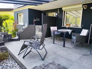 a patio with a chair and a table on it at Kleines Moselchalet in Cochem