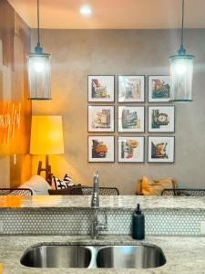 a kitchen with a sink and some pictures on the wall at Neon Daes Amazing 1 Bedroom Near Vandy and Broadway in Nashville