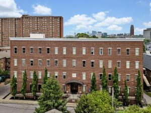 a large brick building with trees in front of it at Neon Daes Amazing 1 Bedroom Near Vandy and Broadway in Nashville