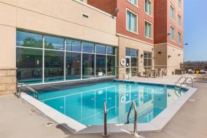 a swimming pool in front of a building at Drury Plaza Hotel Denver Central Park in Denver