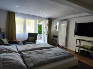 a bedroom with two beds and a flat screen tv at Kleines Moselchalet in Cochem