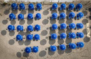 an overhead view of a group of blue chairs at The Beach Camping Village in Marina di Carrara
