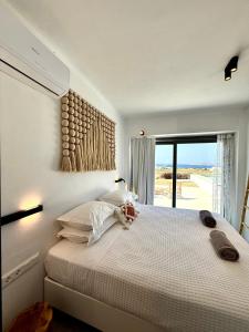 a bedroom with a bed with a view of the ocean at Faragas Hill Oasis Villa in Angairiá +38 photos