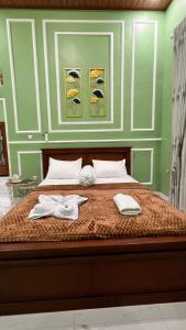 a bed with two towels and shoes on it at NH Villa in Sangyang +92 photos