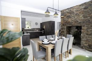 a dining room and kitchen with a table and chairs at Devon Hot Tub Retreat in Bideford