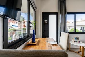 un salon avec une table et une grande fenêtre dans l'établissement Enchanting and centric flat - Puerto de la Cruz, à Puerto de la Cruz