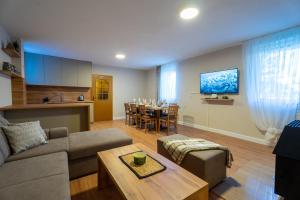 a living room with a couch and a dining room at Blidinje Bliss in Risovac