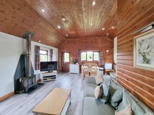 a living room with a couch and a fireplace at Holly 7 Hot Tub in Garton