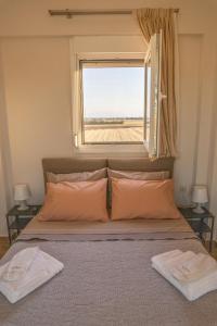 a bedroom with a bed with a window at Star View Home in Alexandroupoli