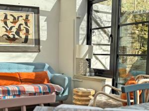 a living room with a blue couch and a window at Little Brook Cottage in Hebden +13 photos