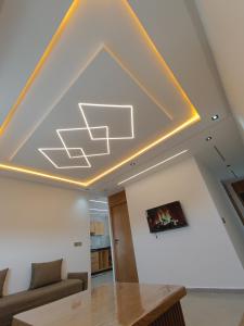 a living room with a ceiling with a yellow at BlueSea Studio's &Appart in Oualidia