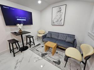 a living room with a couch and a table and chairs at Comfy Tiny Home WP Large Private Deck Queen bed in Orlando