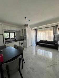a kitchen and living room with a table and a couch at Doğan Homes Likya in Demre