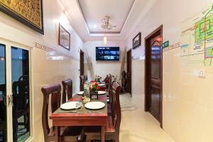 a dining room with a wooden table and chairs at 855 Villa S R in Siem Reap