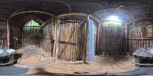 an inside view of a room with a wooden wall at Selvista Guesthouses in Balgue