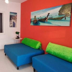 two blue and green ottomans in a room at Vistas al mar 2 in Tías