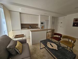 a living room with a couch and a table at Apartamento Reyes Católicos in Córdoba +8 photos