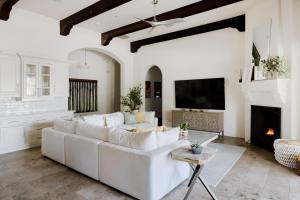 a living room with a white couch and a fireplace at Casa Consola in Scottsdale