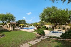a backyard with a swimming pool and trees and a house at Casa Consola in Scottsdale